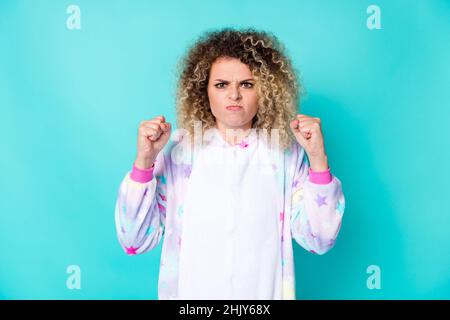 Photo of mad young curly hairdo lady want fight wear pajama isolated on blue background Stock Photo
