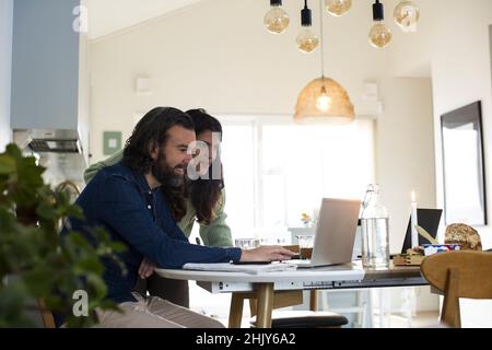 Mature couple using laptop on table at home Stock Photo