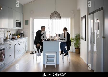 Girlfriend talking with boyfriend while working at home Stock Photo