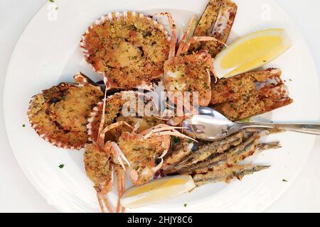 Mixed Mediterranean fish fried with scallops, crabs, razor clams, anchovies Stock Photo