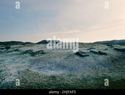 View S from the NW entrance of Arbor Low, Derbyshire, UK: an oval setting of recumbent limestone slabs within the ditch & bank of a henge monument. Stock Photo