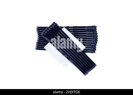 Top view of black hair pins isolated on white background. Group of bobby pins. Stock Photo