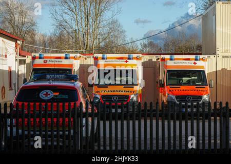 Four medical rescue vehicles in a car park of the German Red Cross are waiting for their mission. Stock Photo