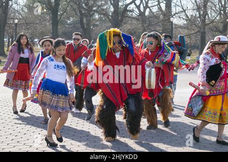 During a video shoot, a group of Ecuadorian dancers & musicians perform alongside the Unisphere in a  park in Queens, New York City. Stock Photo