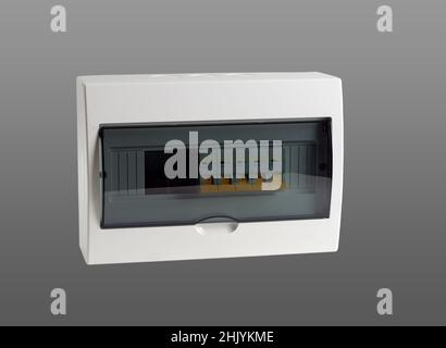 Plastic distribution board. Electrical board. Close-up. Isolated on gray background. Stock Photo