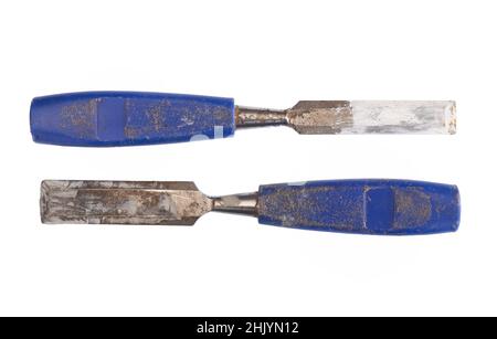 Two old blue chisels, plastic handles, also used as paint stirers. Isolated on white background. Stock Photo