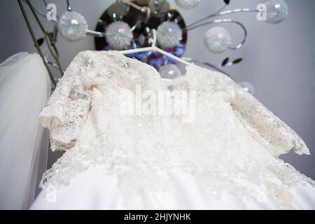 White wedding dress embroidered with beads hanging on chandelier Stock Photo - Alamy White wedding dress embroidered with beads hanging on chandelier Stock Photo - Alamy