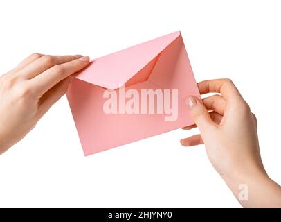 Woman hands holding and opening pink love letter isolated on white background. Valentines day concept. High quality photo Stock Photo