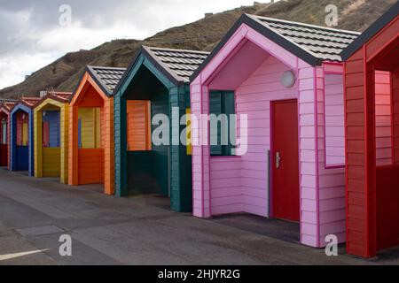 Brightly coloured beach huts Stock Photo