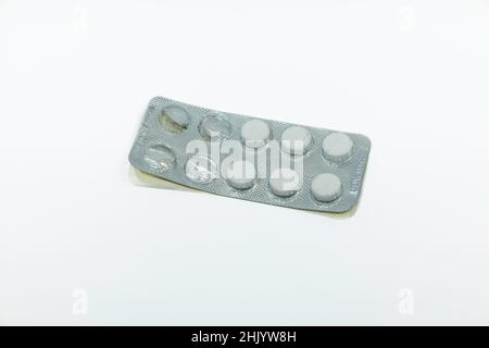 Medications pills in the blister pack. Four tablets are missing Stock Photo