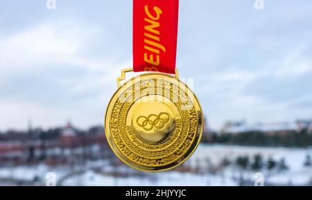 January 31, 2022, Moscow, Russia. Gold medal at the XXIV Olympic Winter Games in Beijing with the Moscow Kremlin in the background. Stock Photo