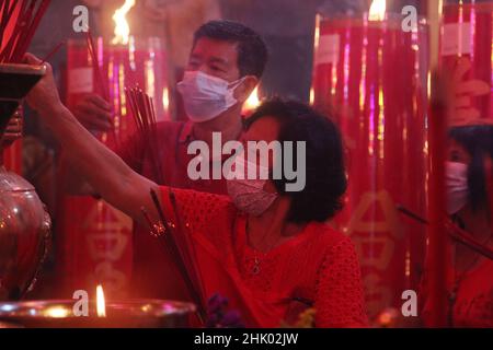 West Java, Indonesia, on January 31, 2022. A number of congregants pray the eve of Chinese New Year at the Hok Lay Kiong Temple, which was founded in the 18th century and is the first and largest pagoda in the city of Bekasi, West Java, Indonesia, on January 31, 2022. Because it is still in the atmosphere of the Covid-19 pandemic and in the midst of increasing Covid-19 cases, the Omricon variant, by the temple management, tonight's worship is held in a limited manner and the number of people allowed to pray is a maximum of 50 people in turn. (Photo by Kuncoro Widyo Rumpoko/Pacific Press) Stock Photo