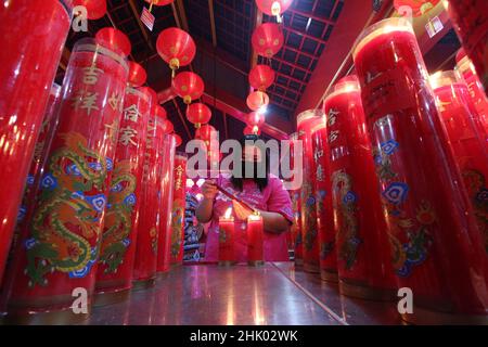 West Java, Indonesia, on January 31, 2022. Congregants pray the eve of Chinese New Year at the Hok Lay Kiong Temple, which was founded in the 18th century and is the first and largest pagoda in the city of Bekasi, West Java, Indonesia, on January 31, 2022. Because it is still in the atmosphere of the Covid-19 pandemic and in the midst of increasing Covid-19 cases, the Omricon variant, by the temple management, tonight's worship is held in a limited manner and the number of people allowed to pray is a maximum of 50 people in turn. (Photo by Kuncoro Widyo Rumpoko/Pacific Press) Stock Photo