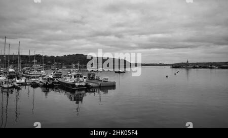 Falmouth harbour looking out to sea with boats in the harbour and a navel ship in the distance Stock Photo