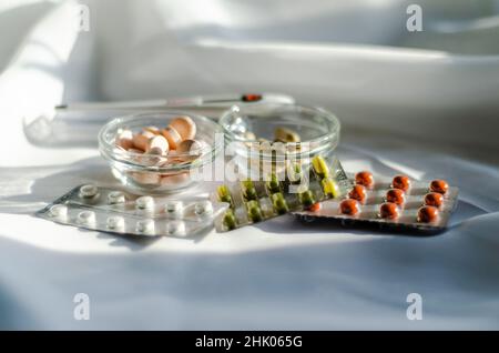 different vitamins and pills on a light background Stock Photo