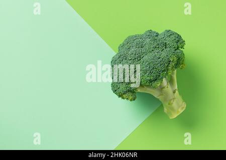 Flat lay composition of broccoli isolated on green background with  copy space. Stock Photo