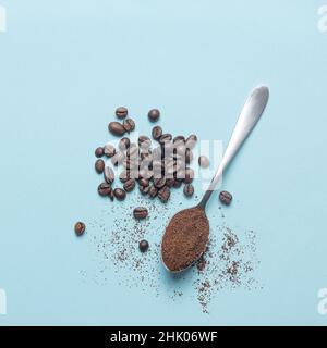 Top view of spoon with coffee and coffee beans isolated  on light blue background. Stock Photo