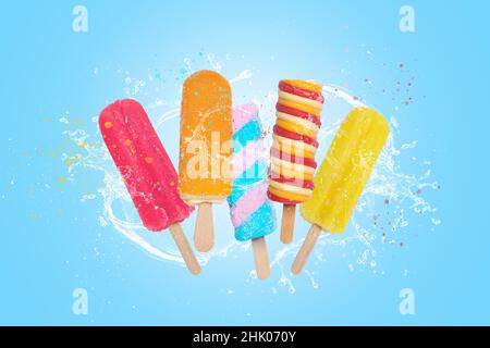 Colorful popsicles ice cream on blue background with splash. Stock Photo