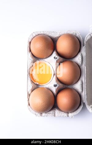 Top view of brown eggs on egg carton isolated on white background. Stock Photo