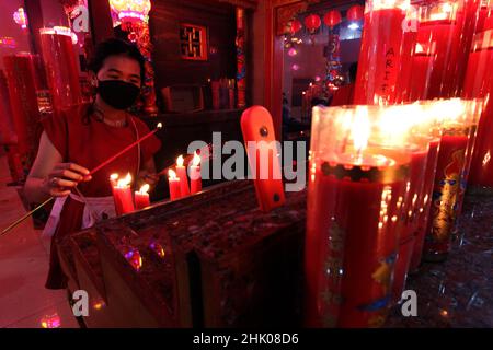 Congregants pray the eve of Chinese New Year at the Hok Lay Kiong Temple, which was founded in the 18th century and is the first and largest pagoda in the city of Bekasi, West Java, Indonesia, on January 31, 2022. Because it is still in the atmosphere of the Covid-19 pandemic and in the midst of increasing Covid-19 cases, the Omricon variant, by the temple management, tonight's worship is held in a limited manner and the number of people allowed to pray is a maximum of 50 people in turn. (Photo by Kuncoro Widyo Rumpoko/Pacific Press/Sipa USA) Stock Photo