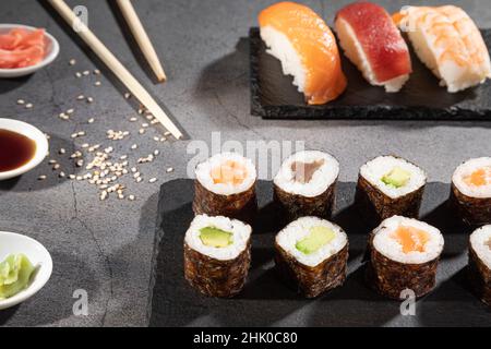 Closeup of fresh variety of sushi on dark background. Stock Photo