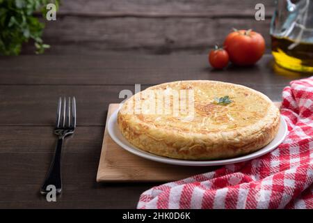 Traditional Spanish omelette dish, on rustic background with copy space. Spanish cuisine. Stock Photo