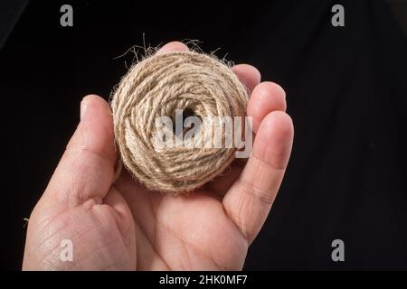 Spool of dark, black thread with needle and one metal thimble on white  background, home crafting, sewing kit, indoors, close-up Stock Photo - Alamy