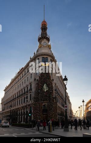 The luxurious Four Seasons hotel with the Hermes shop decorated with a giant Christmas tree against the facade for the wonderful and joyful holidays Stock Photo