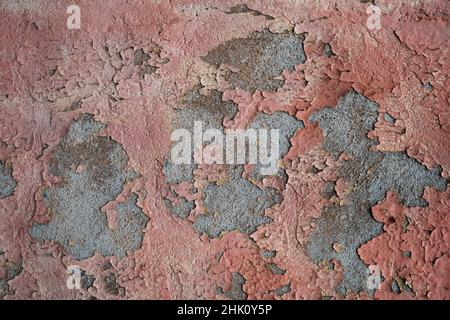 Old distressed wall with pink peeling plaster, grunge texture Stock Photo