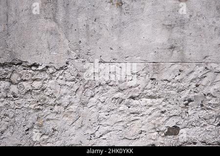 Old traditional white limewash plastered stonework wall Stock Photo