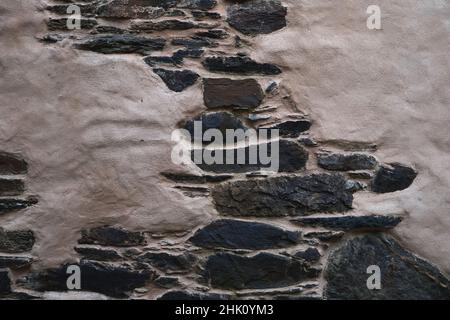 Old traditional stonework wall with plaster finish Stock Photo
