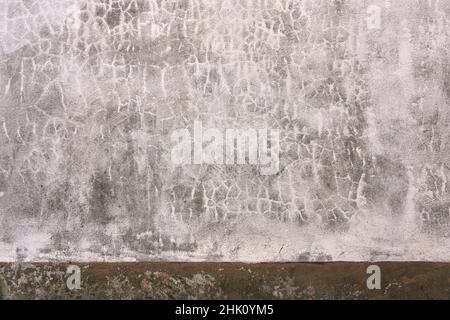 Old whitewashed lime wall with beige skirting board, traditional architecture in La Mancha, Spain Stock Photo
