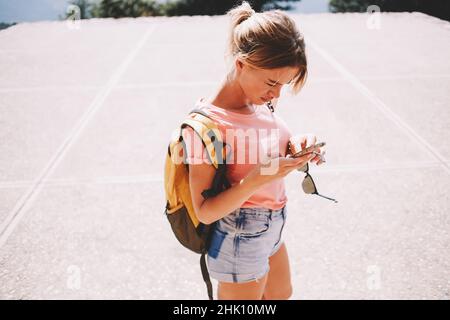 Calm female tourist using smartphone Stock Photo