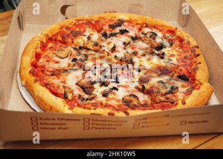 Mushroom and Cheesy Pizza in a Take-out box Stock Photo