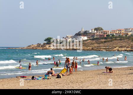 SAN JUAN, ALICANTE, SPAIN - AUGUST 29, 2016: bathers enjoying a day at the beach in San Juan beach on a sunny summer day Stock Photo