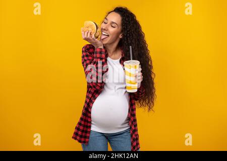 Funny Young Pregnant Lady Holding Burger And Drink Stock Photo