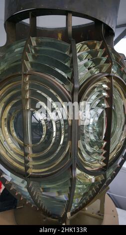 Fresnel lens is a type of composite compact lens in lighthouse. Close image of the glass prisms of lamp of lighthouse. Stock Photo