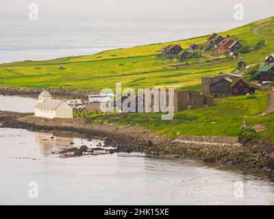 Kirkjubøur, Kirkjubour, Faroe Islands - July 2021: View of the historic cathedral of St. Magnus and Olaf's Church on Streymoy Island in the foggy day. Stock Photo