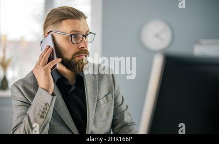 Man talking on mobile at office Stock Photo