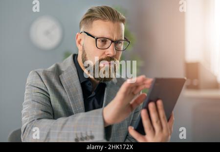Businessman at office with tablet Stock Photo