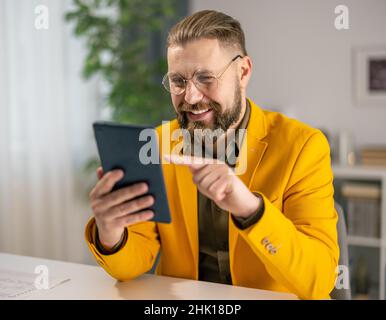 Businessman using tablet at office Stock Photo