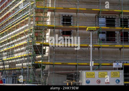 Large construction site, scaffolded shell of an office and commercial building complex, video guard, video surveillance, signs for occupational safety