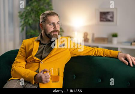 Man with tea on couch Stock Photo