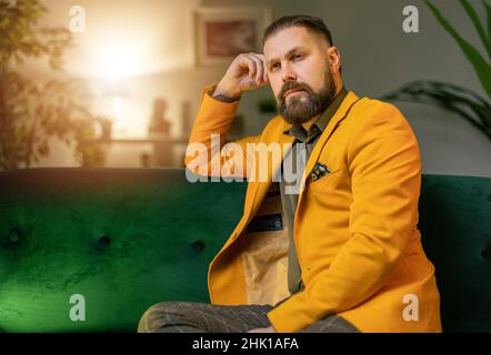 Pensive man on couch Stock Photo