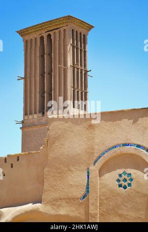 Badgir, a wind tower on the roof in the ancient city of Yazd in Iran, badgir is a traditional Persian architectural feature that creates natural ventilation and cooling in the building Stock Photo