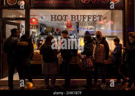 London, UK.  1 February 2022.  People queue outside Young Cheng hot food buffet restaurant in Chinatown on the evening of Chinese New Year as The Year of the Tiger officially begins.  Festivities in Chinatown are scaled back this year due to the pandemic but restaurants will be hoping that business picks up now that Plan B Omicron restrictions have been relaxed by the UK government.  Credit: Stephen Chung / Alamy Live News Stock Photo