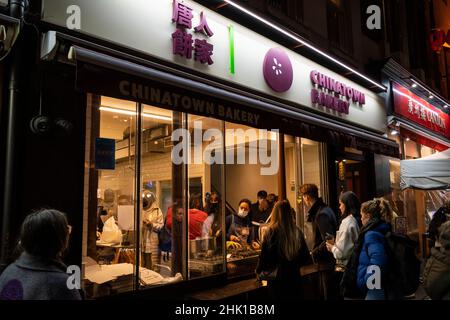 London, UK.  1 February 2022.  People at the Chinatown Bakery on the evening of Chinese New Year as The Year of the Tiger officially begins.  Festivities in Chinatown are scaled back this year due to the pandemic but restaurants will be hoping that business picks up now that Plan B Omicron restrictions have been relaxed by the UK government.  Credit: Stephen Chung / Alamy Live News Stock Photo