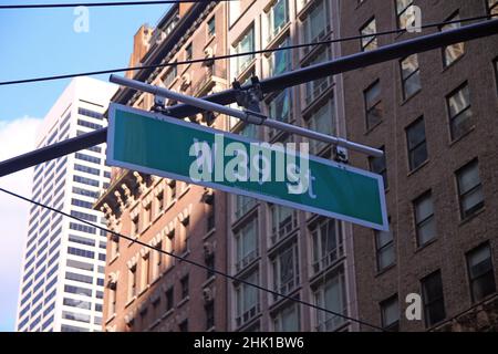 Green big West 39th Street sign hanging on a arch pole in the streets of midtown Manhattan in New York City Stock Photo
