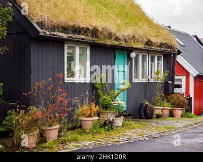 Thorshavn, Faroe Islands - October 2020: Small garden next to a typical turf house in Torshavn on Streymoy Island. Old Town of Torshavn, Faroe Islands Stock Photo