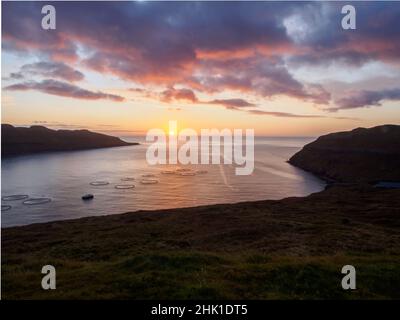 Magic sunrise with beautiful clouds over ocean on Faroe Island. Denmark. Northern Europe Stock Photo